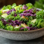 Fresh Chick Fil A kale salad served in a white bowl with honey Dijon dressing drizzle and almonds.