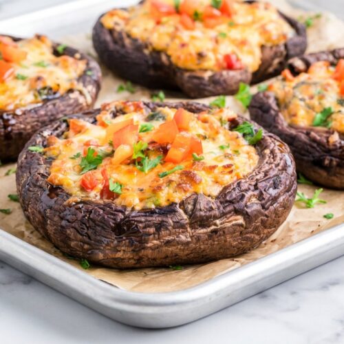 Stuffed Portobello Mushrooms with a savory Umami-Miso Baste on a white marble surface under soft natural window lighting.