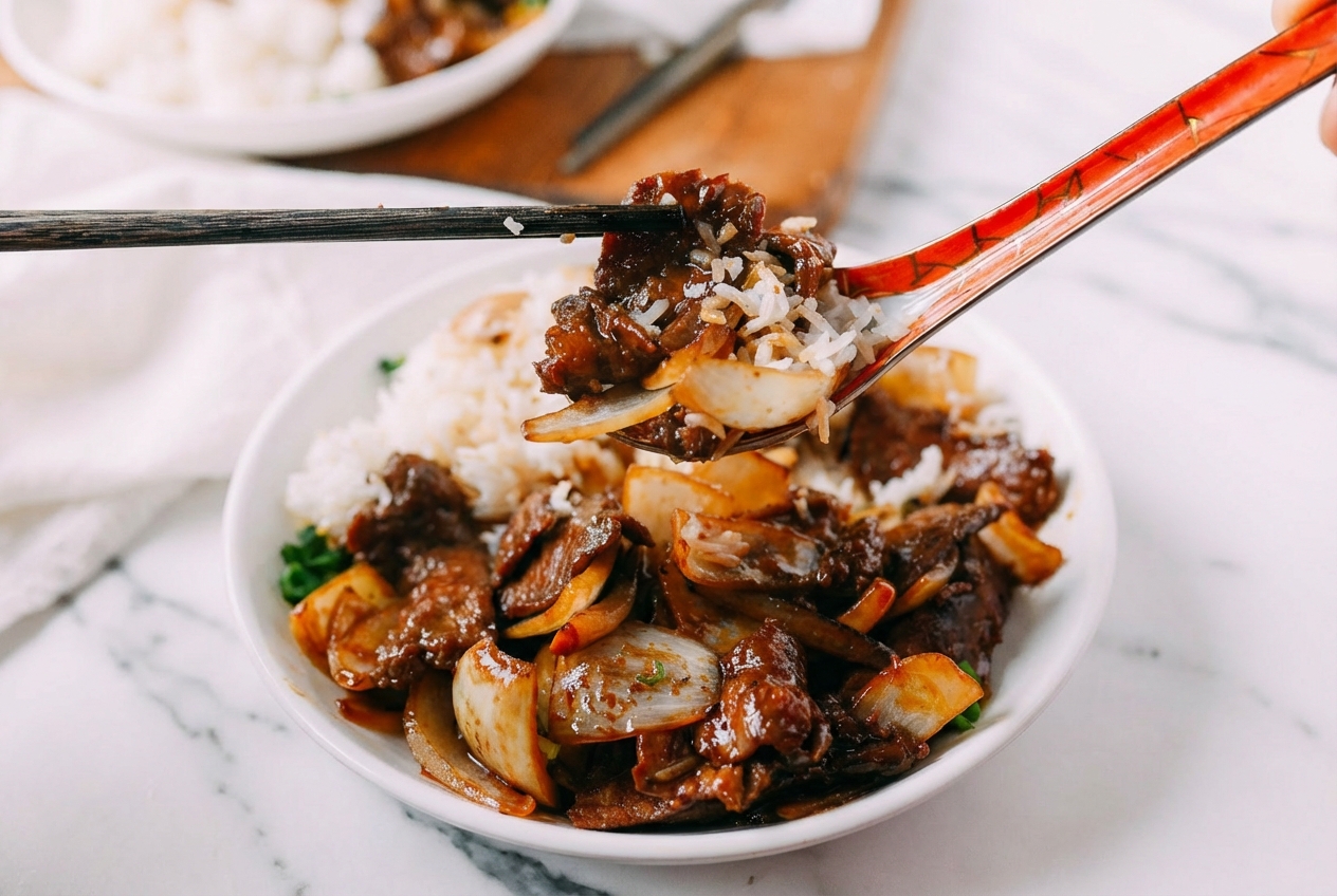 Beef Stir-Fry with Onions on white marble, glossy black vinegar deglaze finish, tender flank steak, natural window light.