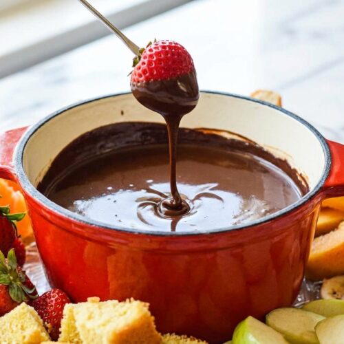 Chocolate fondue recipe in a ceramic bowl on white marble, glossy finish from a touch of coconut oil.