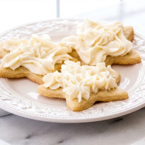 Smooth Sugar Cookie Frosting Recipe with a glossy sheen from corn syrup on a white marble surface.