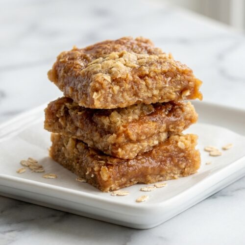 Caramel Crush Bars on white marble featuring a nutty browned butter shortbread crust and gooey caramel.