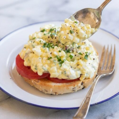 Cottage Cheese Egg Salad featuring a dual-texture emulsion in a white ceramic bowl on a marble surface with soft shadows.