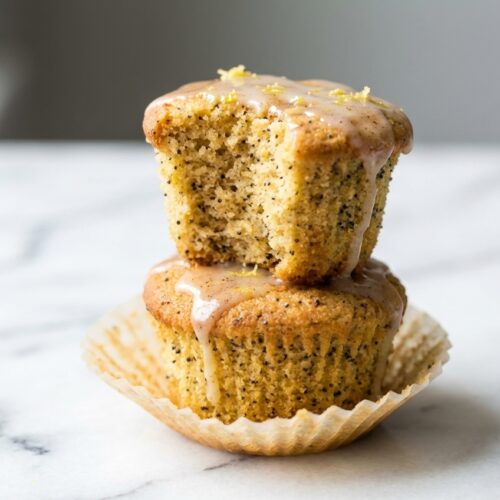 Golden Keto Lemon Muffins with a brown butter and ginger infusion on a minimalist white ceramic plate.
