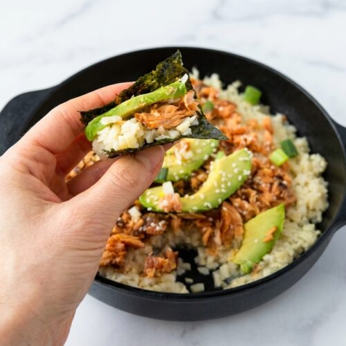 Keto Sushi Bake with a creamy sticky cauliflower rice base served on a minimalist ceramic vessel over white marble.