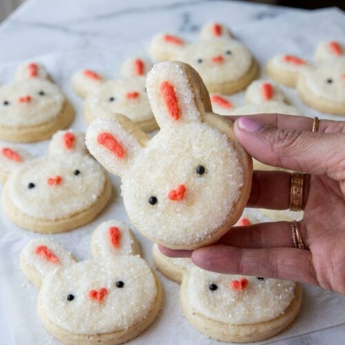 Soft Buttercream Bunny Cookies infused with malted milk powder, styled on a white marble surface with soft natural lighting.