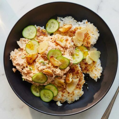 Spicy Tuna Rice Salad Bowl featuring golden rice crisped in garlic-ginger infused oil, served in a ceramic bowl on white marble.
