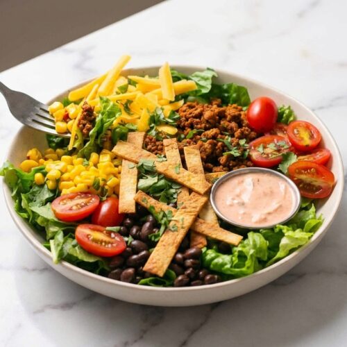 Turkey Taco Salad (29g Protein) in a minimalist ceramic bowl on white marble, highlighting umami-boost browned turkey.