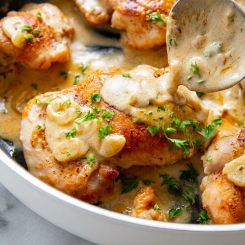 Yummy Garlic Chicken Keto Recipe with a silky Parmesan-Nutmeg Emulsification in a white ceramic bowl on marble.